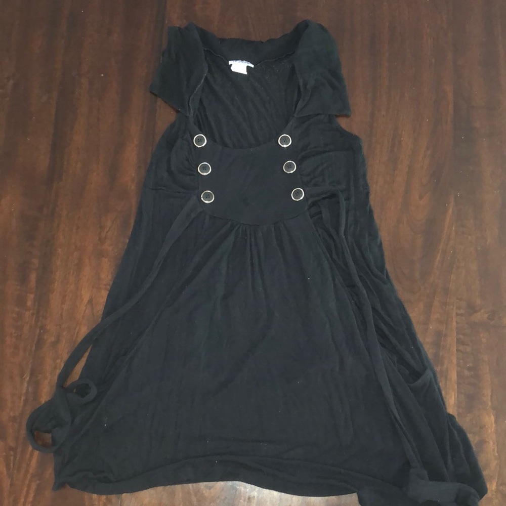 Mid length black dress with buttons.
